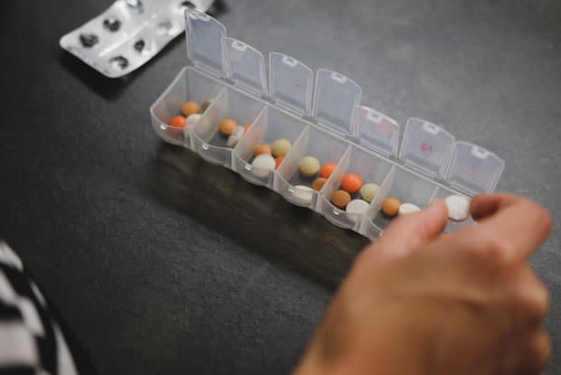 someone using a pill organizer