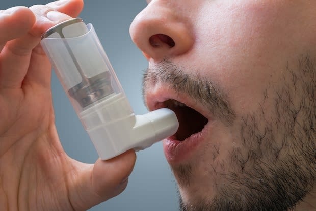 a man using an inhaler