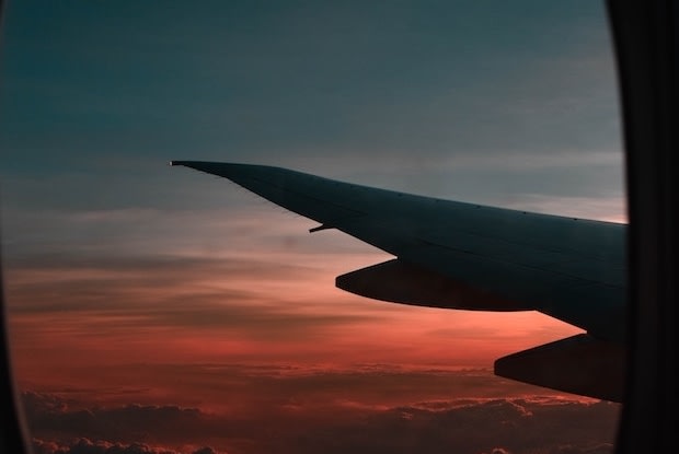 a sunset view out of an airplane window