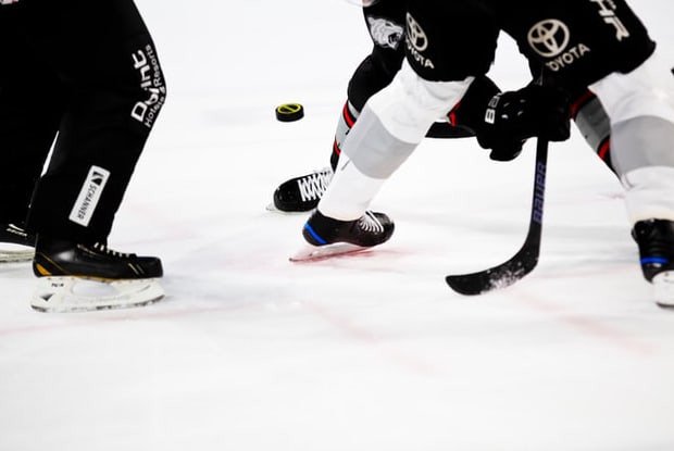 a close-up shot of a hockey face-off)