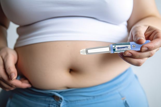 a woman preparing to inject Ozempic into her stomach