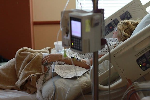 a woman lying in a hospital bed