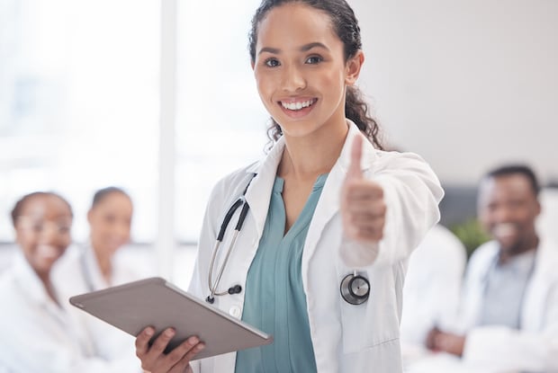 a doctor providing a thumbs-up as a sign of approval for the safety of an online Canadian pharmacy