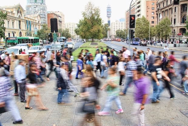 a blurry photo of people walking back and forth across the street