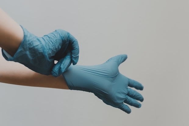 a doctor putting on gloves before a procedure