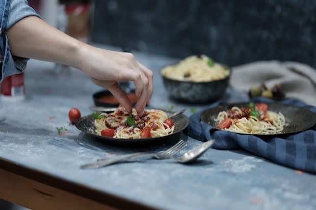 a person picking up food with their hands