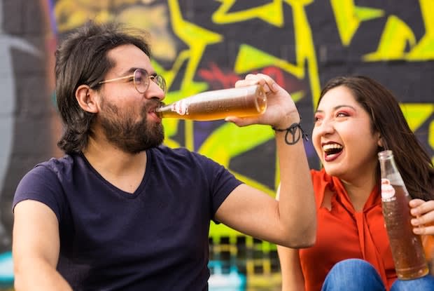 a person drinking out of a soda bottle