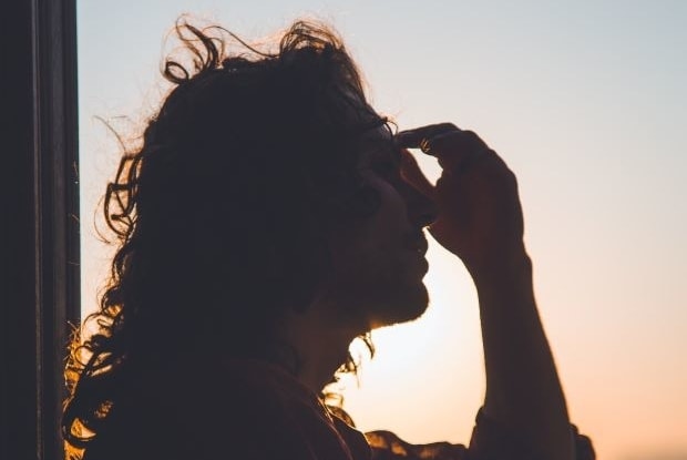 a woman holding her forehead area