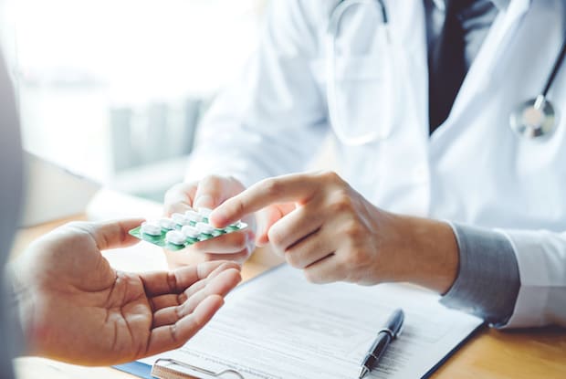 a doctor giving a person pills