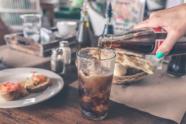 a person pouring soda