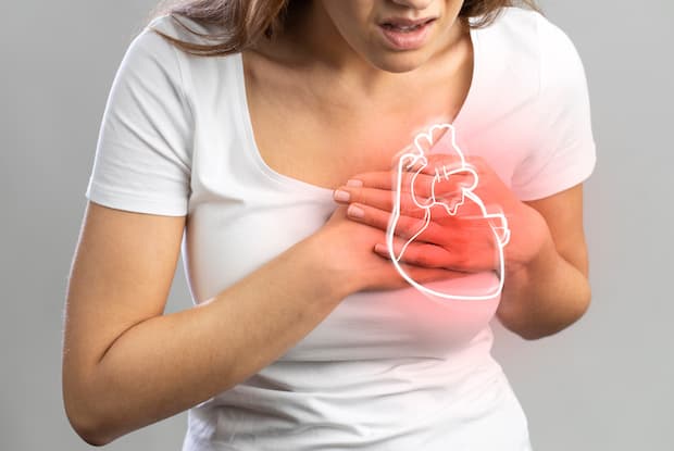 a woman clutching her chest in pain