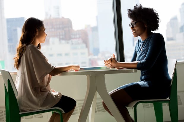 two people having a talk at a table