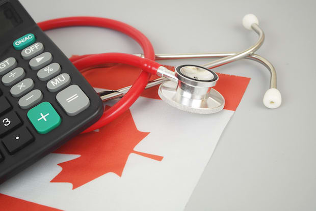 a stethoscope and a calculator on a Canadian flag