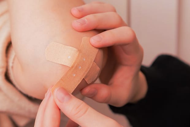 a friend helping to apply bandages