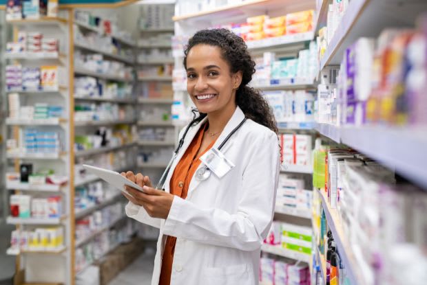 a pharmacist using a digital tablet in a pharmacy