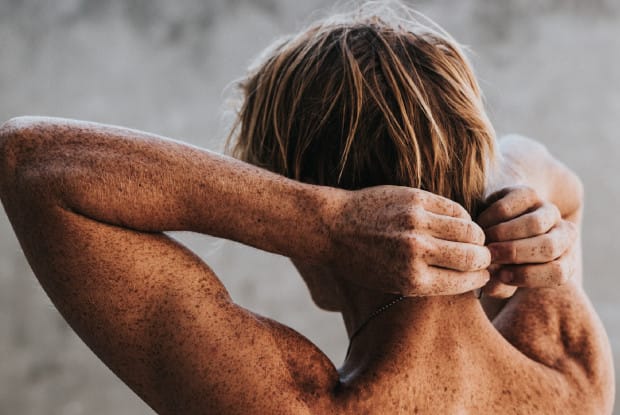 a shirtless man facing away