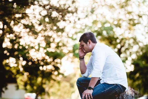 a man cradling his head in distress