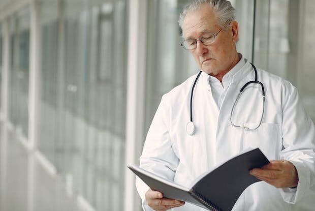 A doctor looking at a file