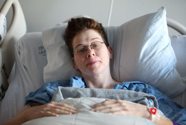 a person laying in a hospital bed