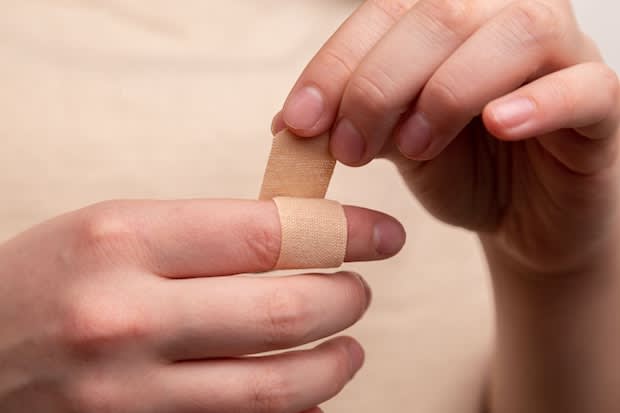 a person applying a bandage