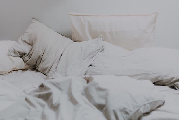 a bed with white bed sheets