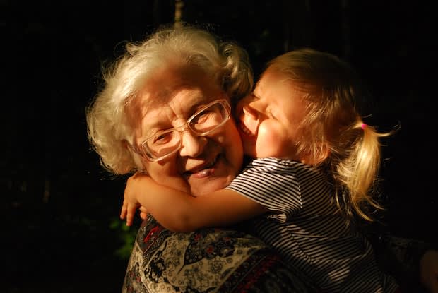 a grandmother and her granddaughter hugging