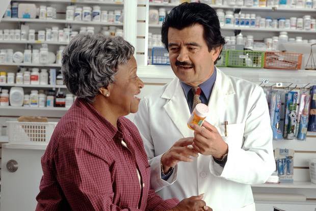 a pharmacist advising a woman on her medications