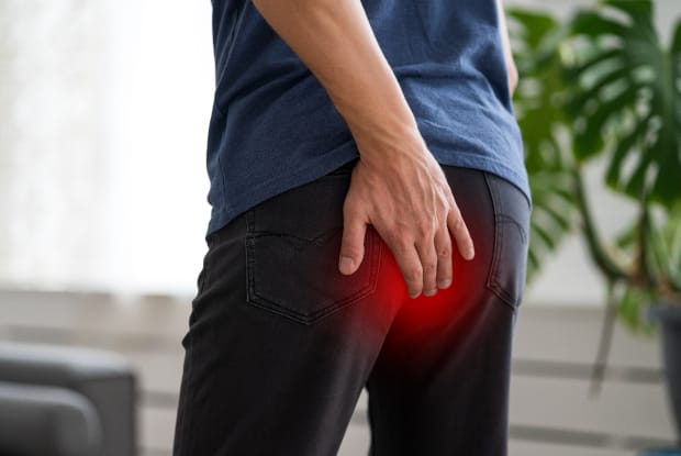 a glowing red that indicates a man experiencing hemorrhoids