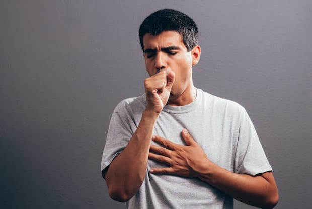 a man coughing