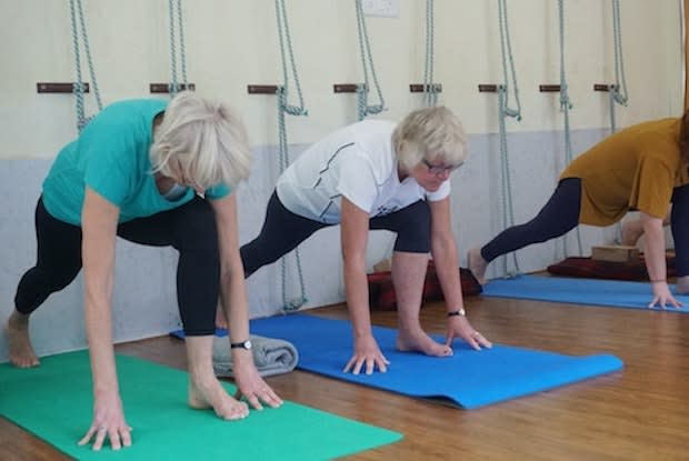 older women doing yoga