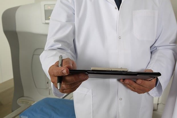 a doctor holding a clip board