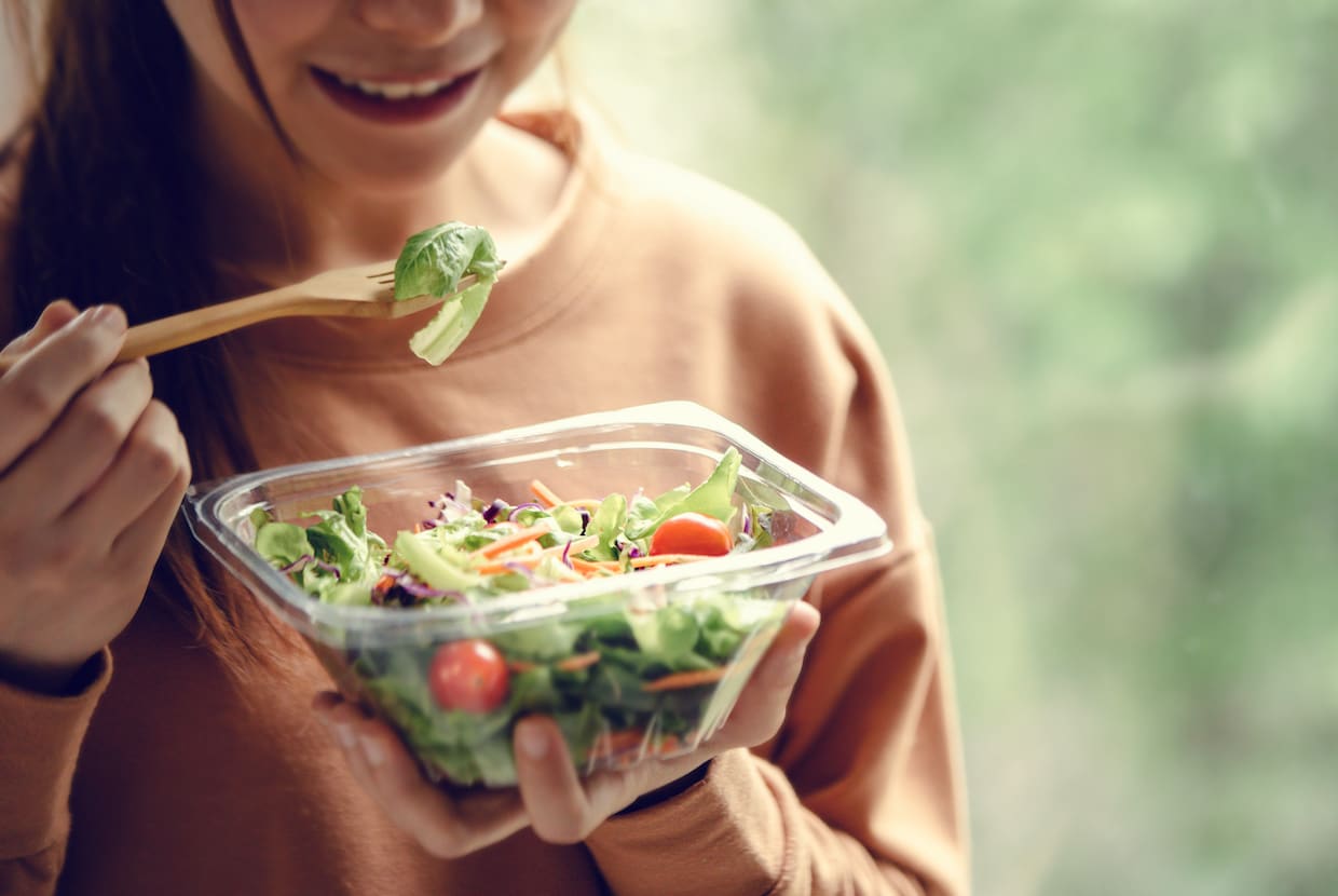 a woman eating a salad