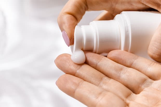 a person putting cream on their hands