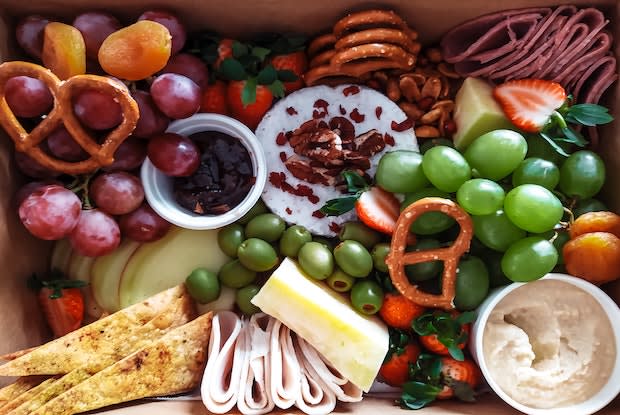 a platter full of fruit and cheeses