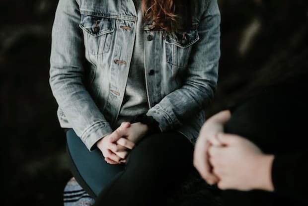 a woman talking to another person