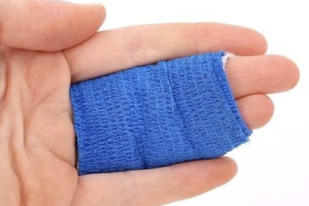 a hand bandaged with blue tape