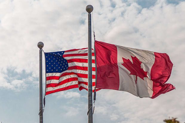 a Canadian and American flag next to each other