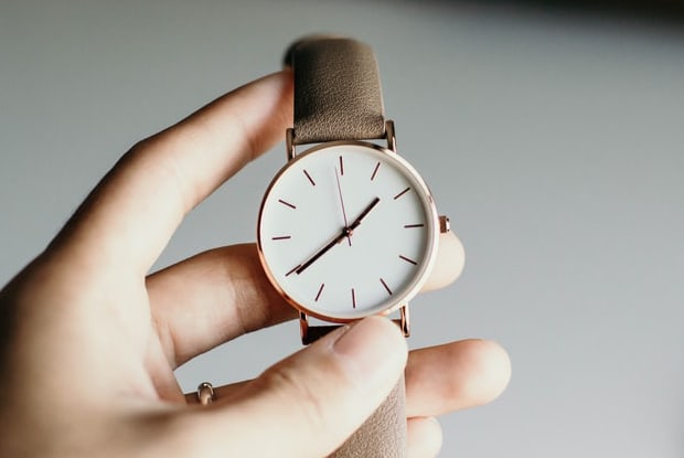 a person holding a wristwatch