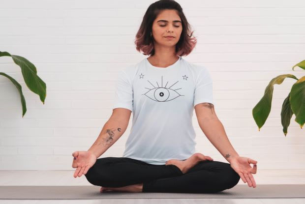 a woman sitting in a yoga position