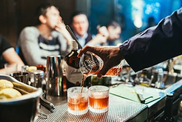 a bartender pouring drinks