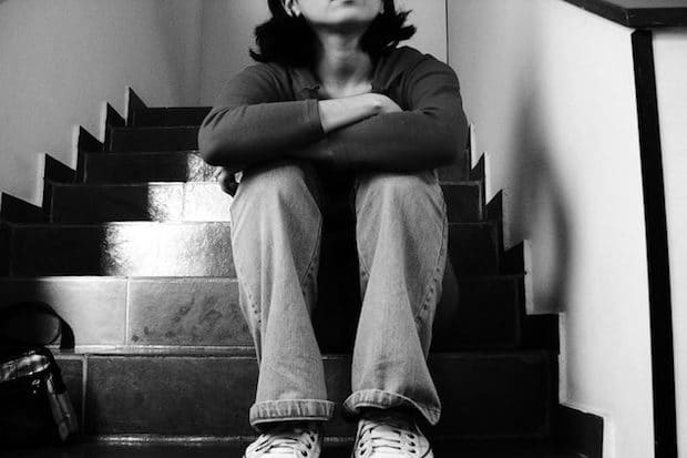 a woman sitting on a set of stairs