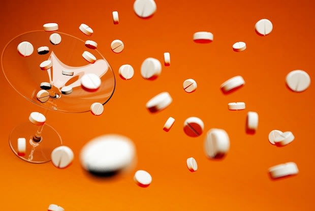 pills on an orange backdrop