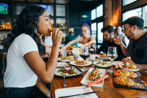 a woman eating at a restaurant