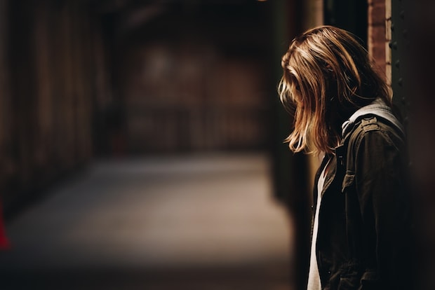 a person standing alone in a dark setting