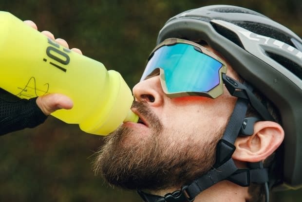 a man drinking out of a water bottle