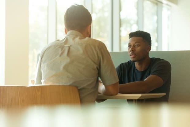 two men sitting at a table