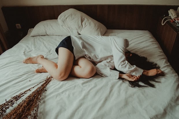 woman laying on bed