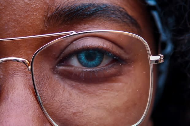 a person wearing glasses instead of contact lenses