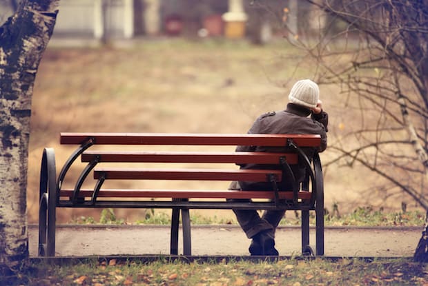 a person sitting on a bench alone
