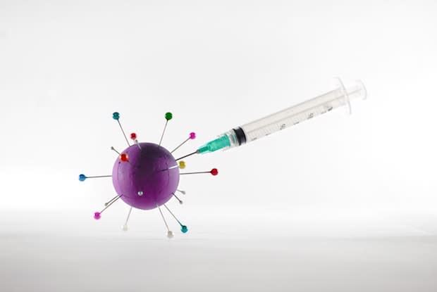 a syringe going into a cartoon virus